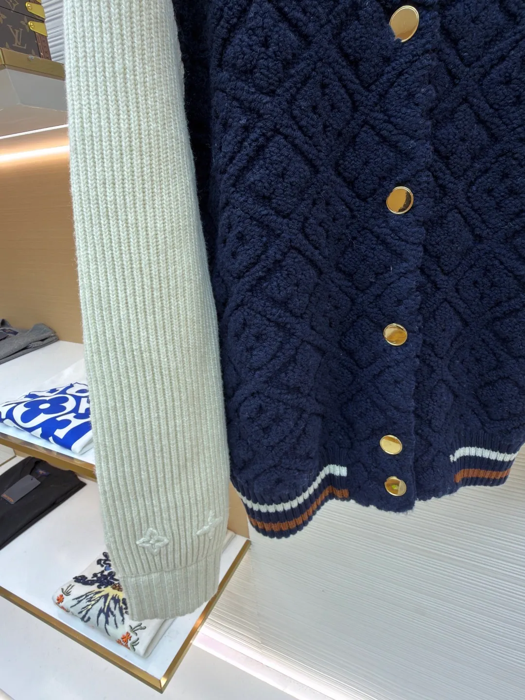 LOUIS VUITTON SKI ski series color-blocked striped baseball long-sleeved jacket ●Original version: purchased and developed for 22999 ●Item number: 1682091-D35 ●Fabric: wool blended fabric ●Technology: knitted ●Color: blue and white ●Version: fitted version ●Weight: about 1070 grams ●Size: S-M-L-XL ●Description: This Louis Vuitton color-blocked knitted cardigan uses a three-dimensional cable knitting process to create the main body. It uses high-count merino wool blended fabrics and uses a double needle bed knitting machine to create a concave and convex rhombus texture. The knitting density reaches 32 needles per square centimeter, making the texture both three-dimensional and soft. The main body of the body is made of navy blue fixed-spun yarn, which has been washed and fixed three times to effectively prevent fading. The sleeves are made of off-white vertical pit rib knitting, and the single-strand yarn twist is controlled at 800 twists/meter to ensure resilience and fit. The metal snaps are made of custom-made brass and have been treated with gold-plated glaze sealing. The contrasting ribs on the collar and hem are intarsia woven, accurately matching the proportions of the brand's classic three-color webbing. The cuffs also have a hidden laser-engraved brand logo. The overall process combines traditional knitting techniques with modern precision, and the details are full of craftsmanship. The overall wiring is straight and delicate, the fabric is comfortable and soft, and the color is consistent without color difference. It can be matched with the same style to create a fashionable look and control various occasions. Customized accessories, complete with three standards, same style for men and women!
